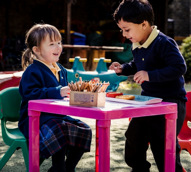 children colouring outside