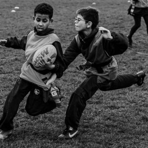 children playing rugby black and white