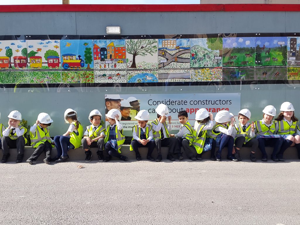 children dressed in hi-vis jackets and helmets