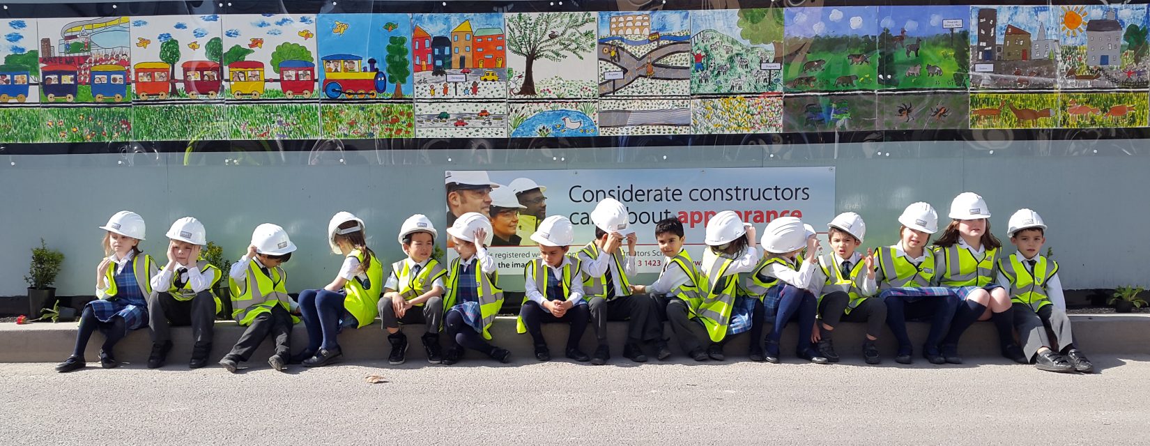 children dressed in hi-vis jackets and helmets