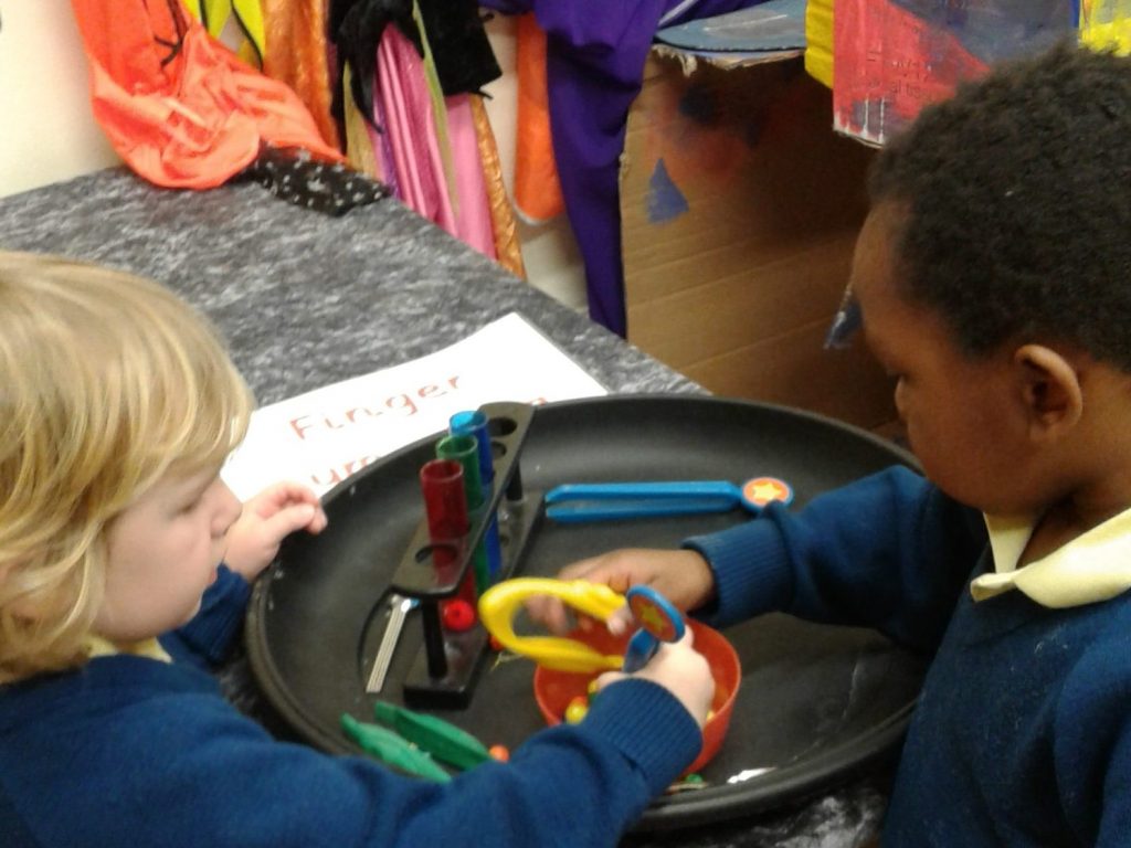 children playing with toy test tubes