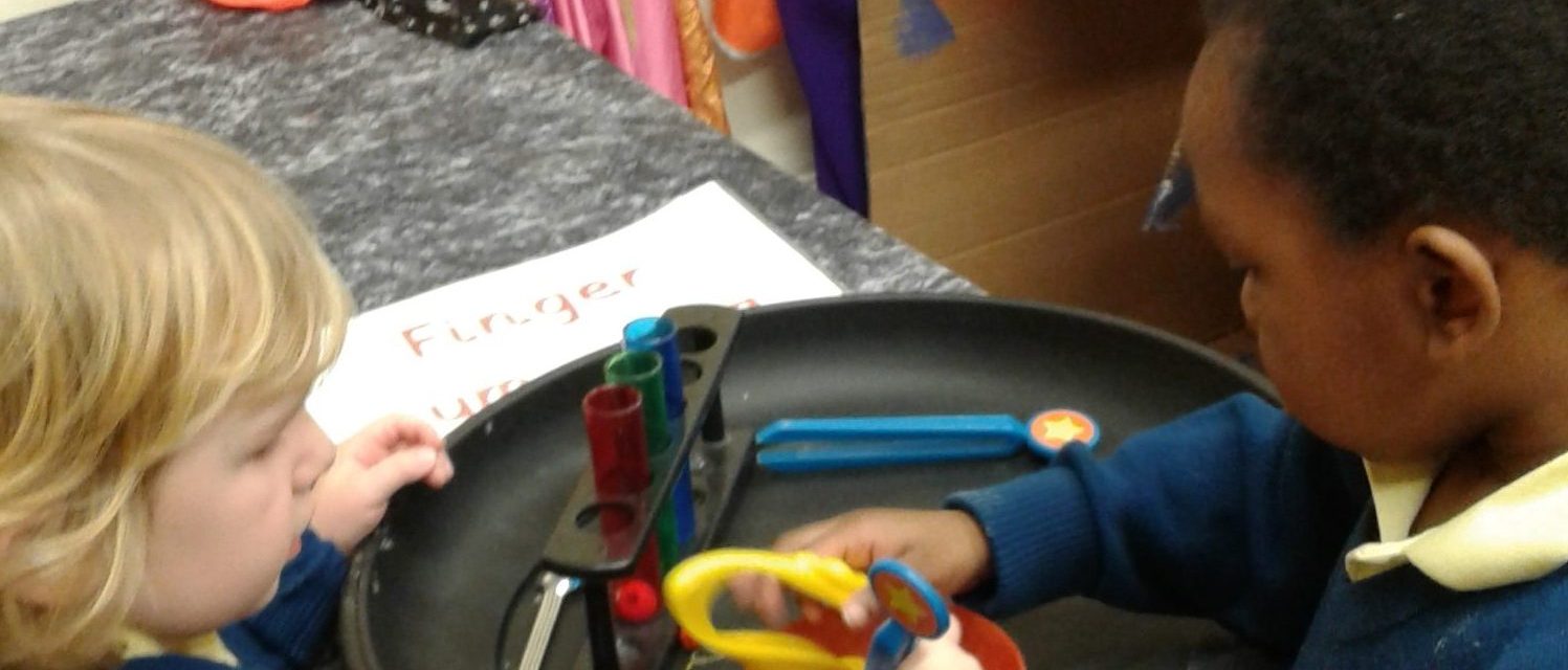 children playing with toy test tubes