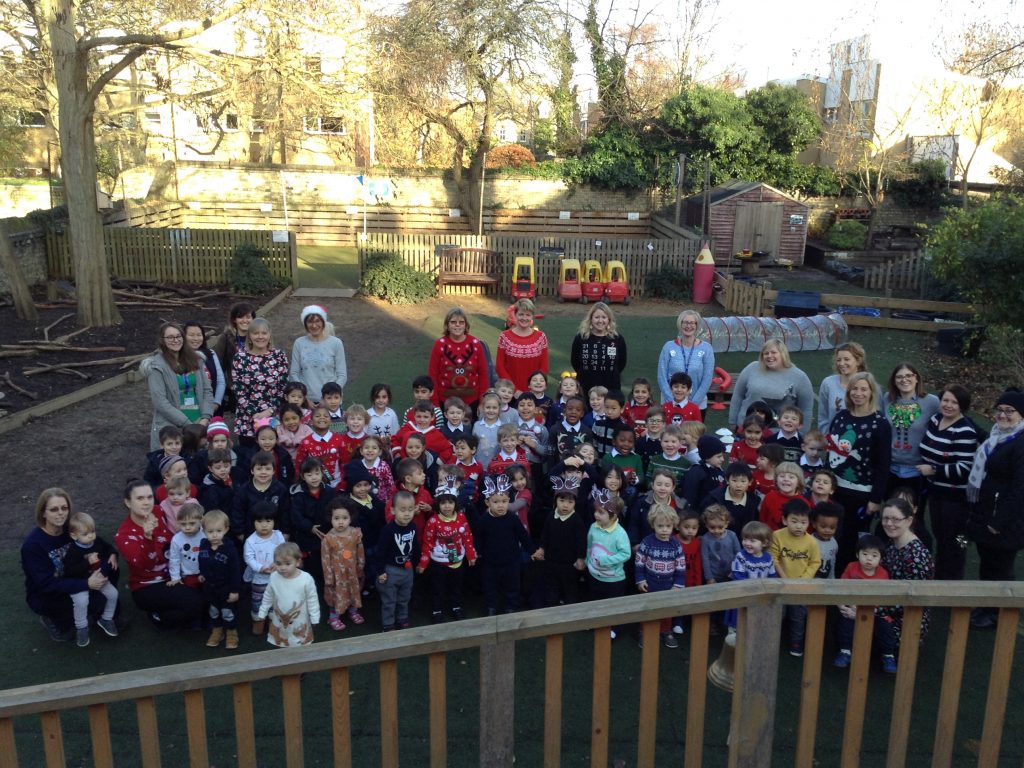 Large group of students with their teachers, wearing Christmas Jumpers