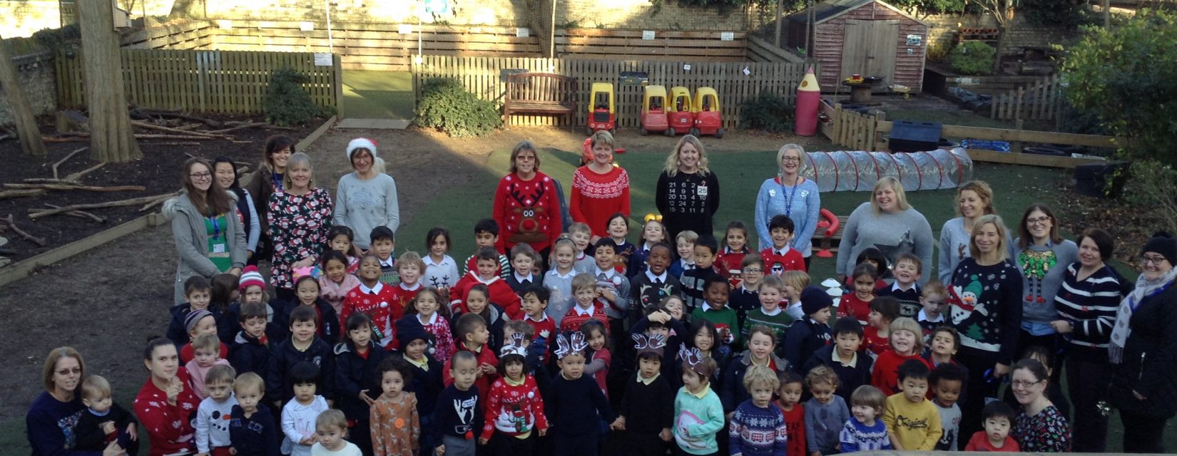 Large group of students with their teachers, wearing Christmas Jumpers