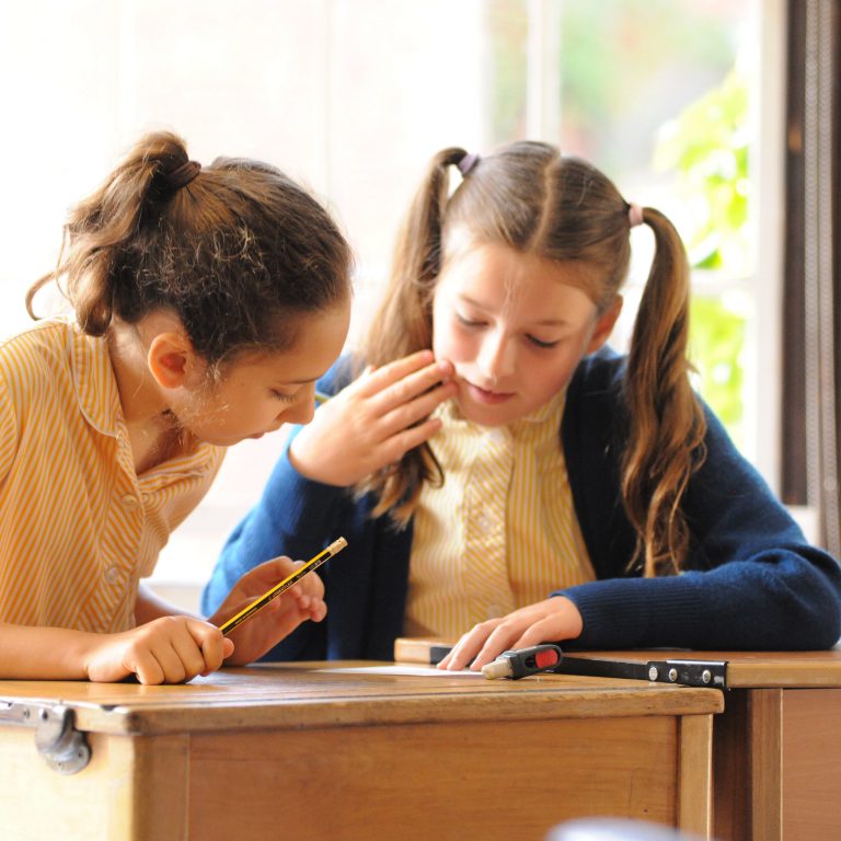 2 students looking at the answers on a worksheet