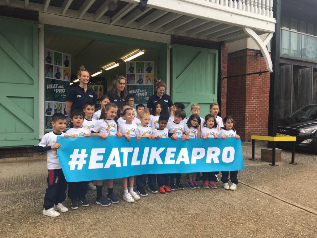 Students holding a banner that reads #EATLIKEAPRO