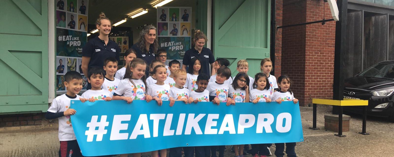 Students holding a banner that reads #EATLIKEAPRO