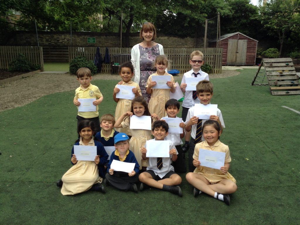 children holding up sheets of paper