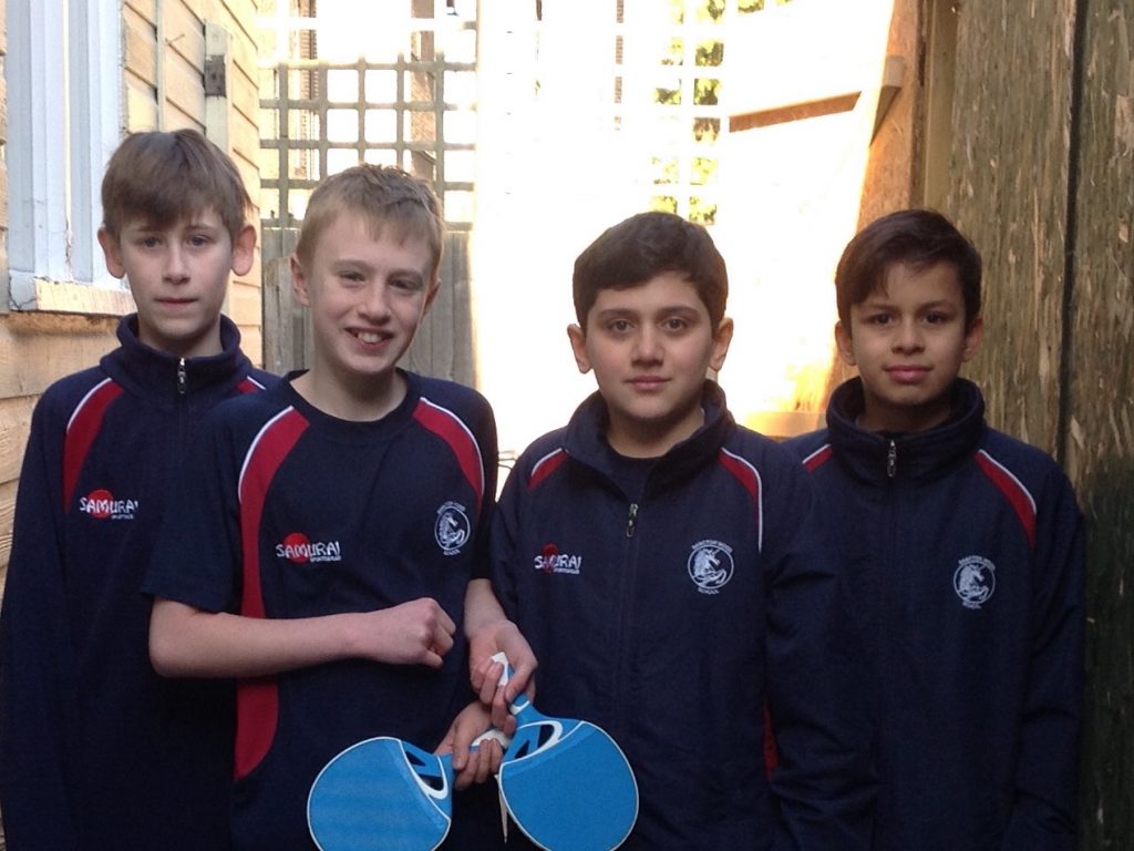 students holding table tennis paddles
