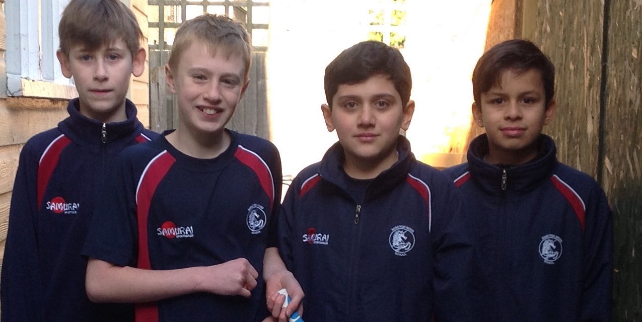 students holding table tennis paddles