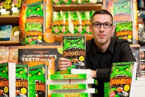 author holding his book