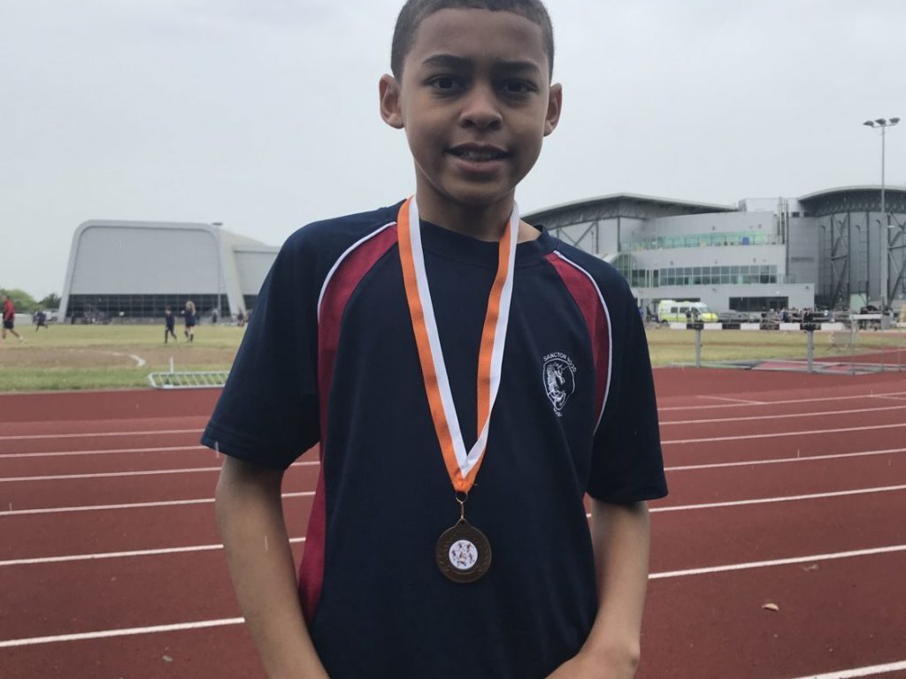 student with a medal around his neck