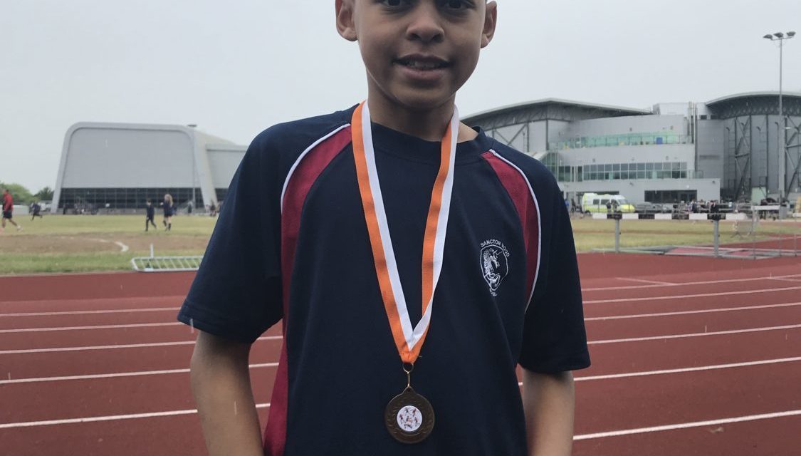 student with a medal around his neck