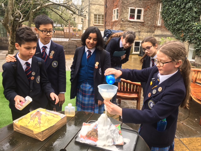 children creating a model volcano