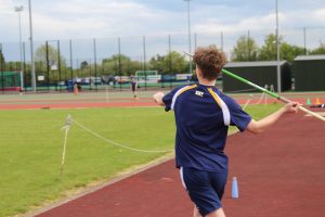 student throwing a javelin