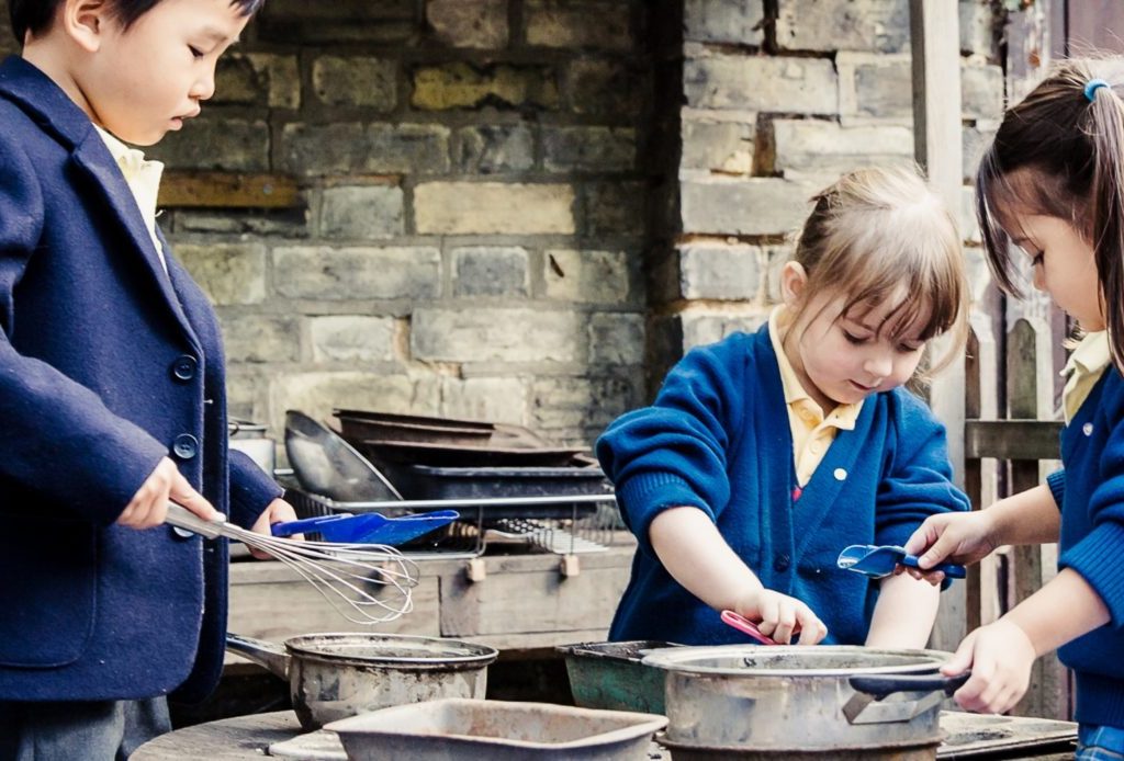 3 students using cooking utensils