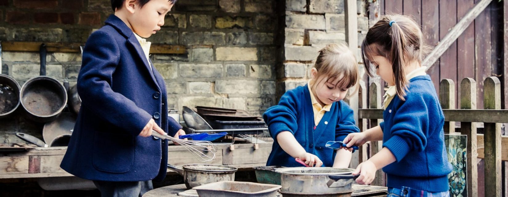 3 students using cooking utensils