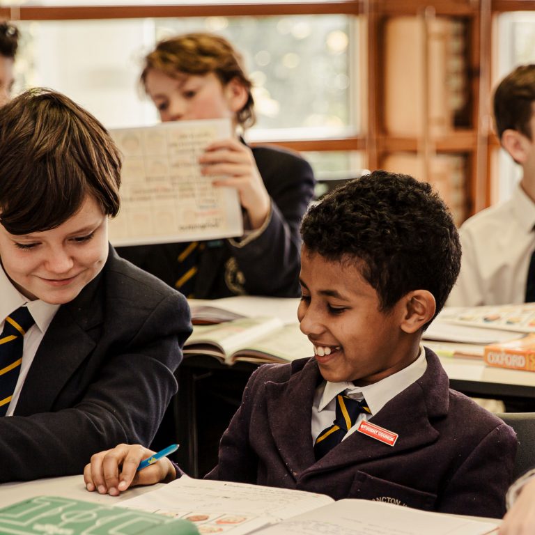 children doing work and smiling