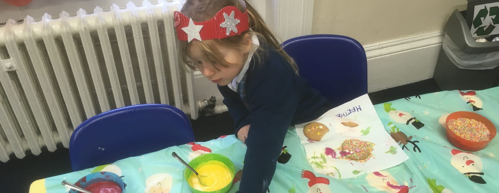 Young girl making cookies with different toppings