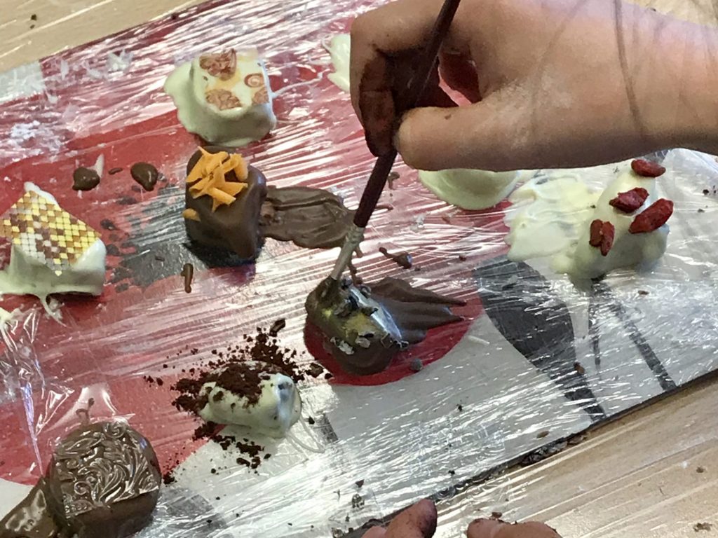 Chocolate creations on a slab of cling film