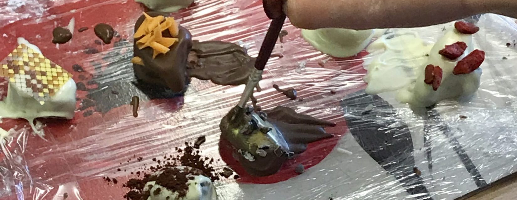 Chocolate creations on a slab of cling film