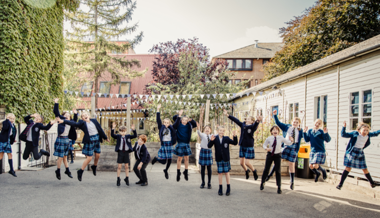pupils in uniform jumping