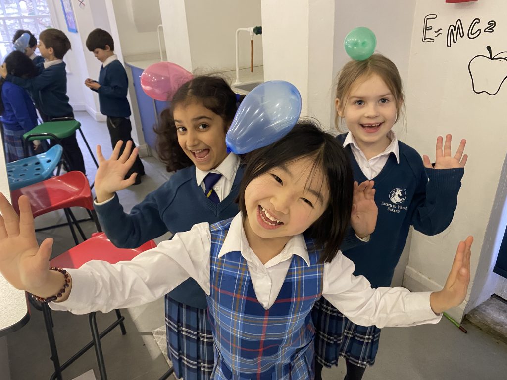 children with static balloons on their hair