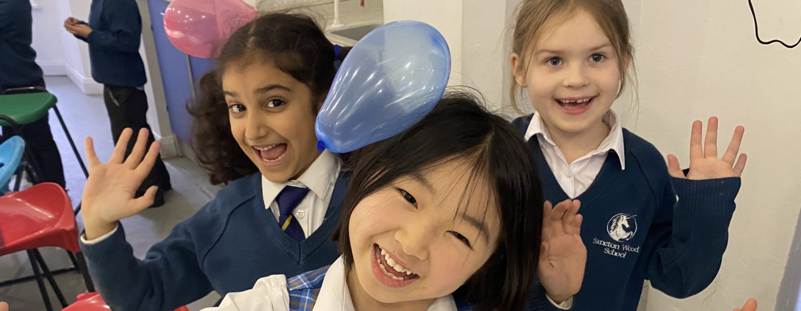 children with static balloons on their hair
