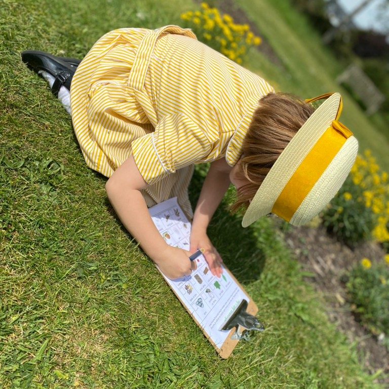 child using a clip board to take notes