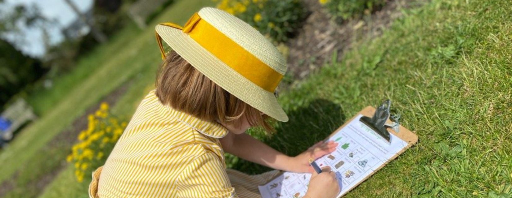 child using a clip board to take notes