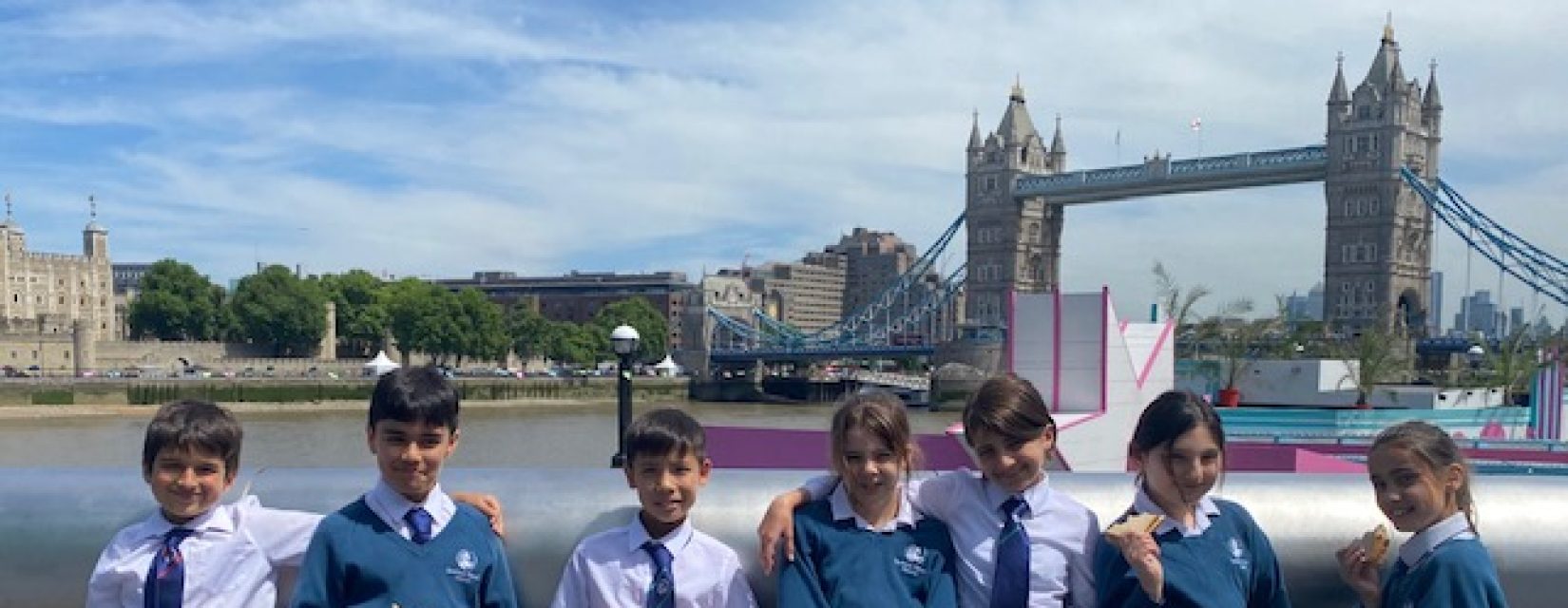 children standing infront of Tower Bridge