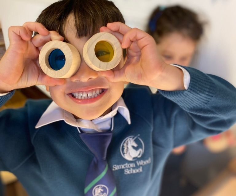 student looking through coloured circles