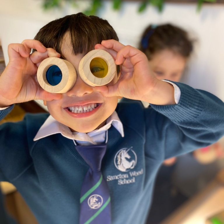 student looking through coloured circles