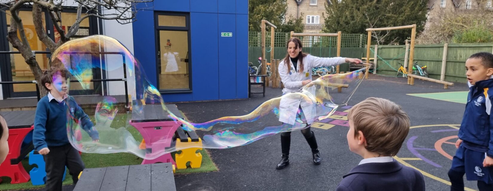 students looking at a big bubble