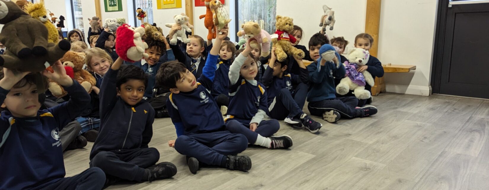 students holding stuffed animals